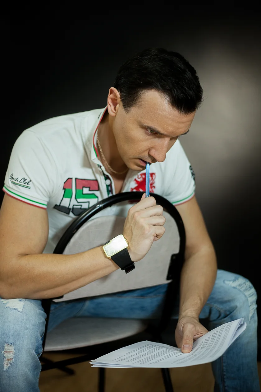 Roman considers a script, holding a pencil near his face
