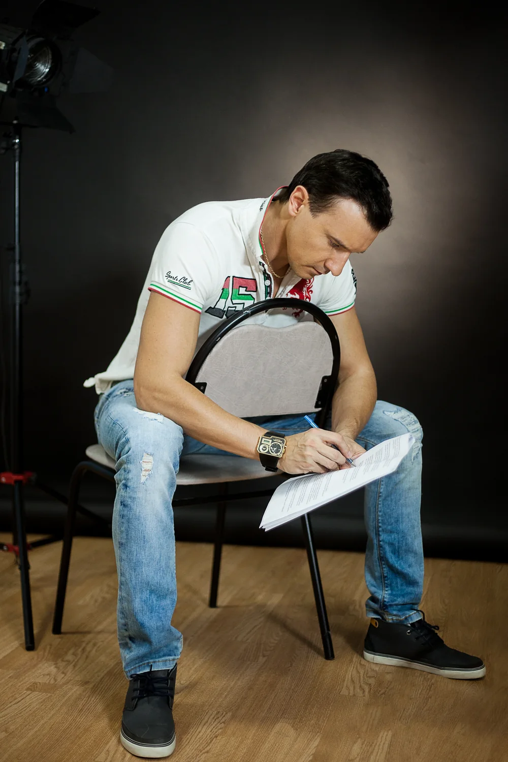 Roman writes notes on a script